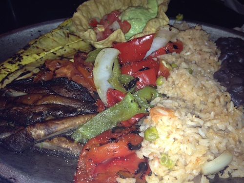 plate of black beans, rice and grilled vegetables for fajitas