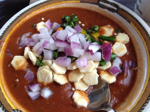 vegan bean chili with crackers and onions on top