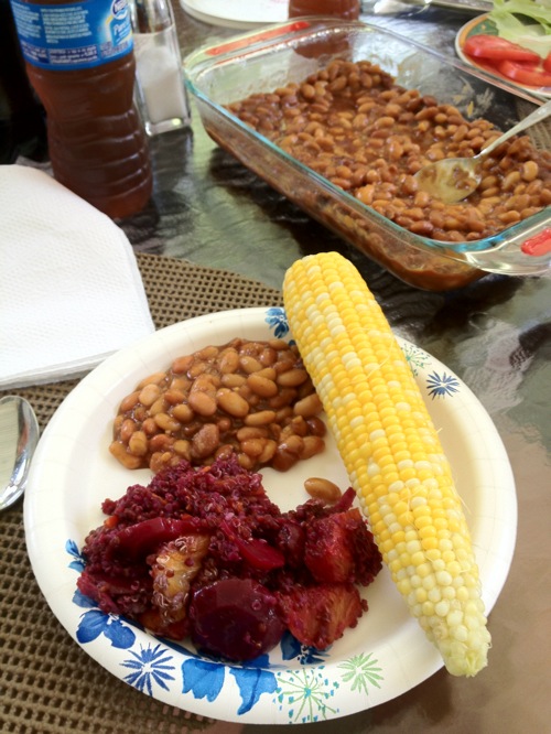 plate with baked beans and an ear of corn