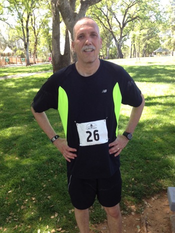 man in running clothing with marathon number attached to his stomach