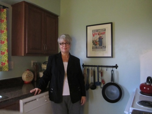 image of same woman standing in kitchen after losing 60 pounds