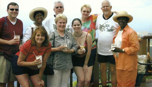 Courtney surrounded by her parents and their friends standing on a balony