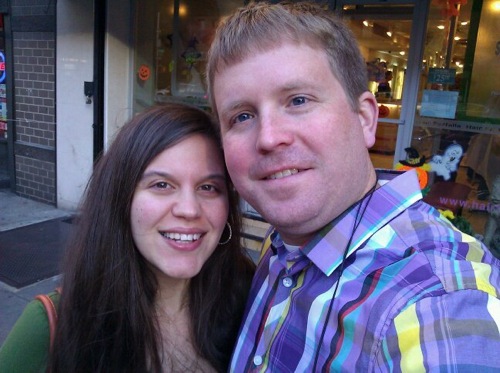 Lindsay and Scott standing on a sidewalk looking at the camera