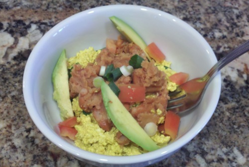 vegan tofu scramble with refried beans, avocado and tomatoes