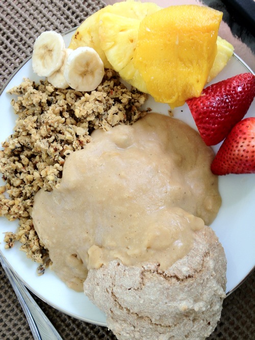 plate of tempeh sausage crumbles and a bisicuit covered in white bean gravy
