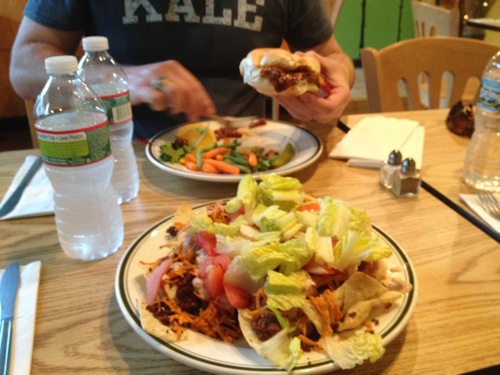 nachos with tomatoes, lettuce, and vegan cheese